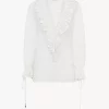 Top con scollo a V e maniche a sbuffo in voile di cotone Top con scollo a V e maniche a sbuffo in voile di cotone
